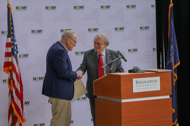 U.S. Senator Chuck Schumer shakes hands with nobel laureate, co-inventor of the lithium-ion battery and distinguished professor at Binghamton University Dr. M. Stanley Whittingham.